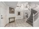 Grand entryway featuring tiled floors, a staircase, and a decorative niche, bathed in natural light at 1066 Aspen Valley Ave, Las Vegas, NV 89123