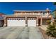 Beautiful two-story home featuring a three-car garage, second-story balcony, and well-manicured landscaping at 1066 Aspen Valley Ave, Las Vegas, NV 89123