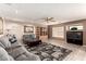 Comfortable living room with plush sofas, tile flooring, a ceiling fan, and abundant natural light at 1066 Aspen Valley Ave, Las Vegas, NV 89123