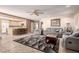 Open-concept living space with tiled floors, comfortable seating, and an adjacent kitchen area at 1066 Aspen Valley Ave, Las Vegas, NV 89123