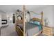 Spacious primary bedroom featuring a four-poster bed, fireplace, and stylish decor at 1066 Aspen Valley Ave, Las Vegas, NV 89123