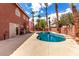 Backyard features a private pool and spa surrounded by palm trees at 1066 Aspen Valley Ave, Las Vegas, NV 89123