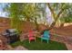 Cozy backyard area with artificial turf, brick wall and a barbecue grill perfect for outdoor entertaining at 11074 Caramel Crest Ct, Las Vegas, NV 89135
