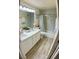 Bathroom featuring double sinks, tiled shower/tub, and modern decor at 11074 Caramel Crest Ct, Las Vegas, NV 89135
