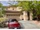 Inviting two-story home featuring a stucco exterior, a two-car garage, and mature landscaping in a desirable neighborhood at 11074 Caramel Crest Ct, Las Vegas, NV 89135