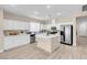 Bright kitchen features white cabinets, stainless steel appliances, and a center island with light countertops at 11074 Caramel Crest Ct, Las Vegas, NV 89135