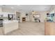Open-concept living space featuring plank flooring, a fireplace, and seamless connection to the kitchen area at 11074 Caramel Crest Ct, Las Vegas, NV 89135
