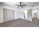 Bedroom features a ceiling fan, closet, ensuite and carpeted floors at 1116 E Owens Ave, North Las Vegas, NV 89030