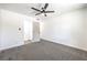 Carpeted bedroom featuring a ceiling fan and ensuite bathroom at 1116 E Owens Ave, North Las Vegas, NV 89030
