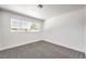 Empty bedroom with carpeted floors and a large window at 1116 E Owens Ave, North Las Vegas, NV 89030
