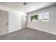 This bedroom features new carpet and large windows at 1116 E Owens Ave, North Las Vegas, NV 89030
