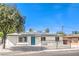 Well-maintained single-story home featuring solar panels, a fenced front yard, and desert landscaping at 1116 E Owens Ave, North Las Vegas, NV 89030