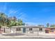 Single story house with solar panels, fenced yard, and tidy front landscaping at 1116 E Owens Ave, North Las Vegas, NV 89030