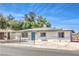 Charming single-story home with solar panels, a fenced yard, and a bright teal front door at 1116 E Owens Ave, North Las Vegas, NV 89030