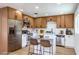 Bright kitchen with stainless steel appliances, wood cabinets, island, and white countertops at 1116 E Owens Ave, North Las Vegas, NV 89030