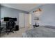 Modern bedroom setup with gray walls, a comfortable bed, a desk setup, and stylish decor accents, a perfect blend of style and function at 12107 Frost Lime Rd # 1, Las Vegas, NV 89183