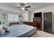 Bedroom with ceiling fan, carpet, natural light, and wood furniture at 12107 Frost Lime Rd # 1, Las Vegas, NV 89183
