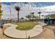 Common area featuring a circular sidewalk, benches, grass, landscaping, and black fencing at 12107 Frost Lime Rd # 1, Las Vegas, NV 89183