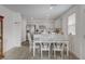 Bright dining area with decorative wood table, white chairs and an open floor plan to the kitchen at 12107 Frost Lime Rd # 1, Las Vegas, NV 89183
