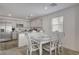 Bright dining area with decorative wood table, white chairs and an open floor plan to the kitchen at 12107 Frost Lime Rd # 1, Las Vegas, NV 89183
