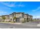 A row of modern townhomes with neutral exteriors, complemented by well-kept landscaping and easy street parking at 12107 Frost Lime Rd # 1, Las Vegas, NV 89183