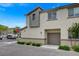 Contemporary two-story home with a one-car garage and neutral stucco and trim on a sunny day at 12107 Frost Lime Rd # 1, Las Vegas, NV 89183