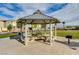 Community gazebo with tables and seating, a grill, and a grassy common area at 12107 Frost Lime Rd # 1, Las Vegas, NV 89183