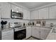 Bright kitchen featuring stainless steel appliances and granite countertops at 12107 Frost Lime Rd # 1, Las Vegas, NV 89183