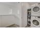 Laundry room area with stacked washer and dryer near stairs at 12107 Frost Lime Rd # 1, Las Vegas, NV 89183