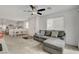 Cozy living room featuring a gray sectional, carpeted floors, and an open layout leading to the kitchen at 12107 Frost Lime Rd # 1, Las Vegas, NV 89183