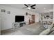 Bright living space with open layout, featuring carpeted floors, stylish furniture, and a view of the dining area at 12107 Frost Lime Rd # 1, Las Vegas, NV 89183