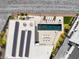 Aerial view showcasing modern home featuring pool, lounge area, solar panels, and a manicured landscape at 13 Rockstream Dr, Henderson, NV 89012