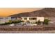 Modern home with a sleek pool, stylish patio furniture, and desert landscaping at 13 Rockstream Dr, Henderson, NV 89012