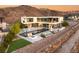 Expansive backyard featuring a modern pool, outdoor seating, and a fire pit area at 13 Rockstream Dr, Henderson, NV 89012
