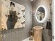 Unique powder room with artistic decor, a stone sink, a modern lighting, and a designer aesthetic at 13 Rockstream Dr, Henderson, NV 89012
