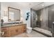 Modern bathroom with wood cabinets, stone countertop, and a sleek glass-enclosed shower at 13 Rockstream Dr, Henderson, NV 89012