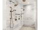 A large walk in shower with dual shower heads and stylish fixtures provides a luxurious experience at 13 Rockstream Dr, Henderson, NV 89012