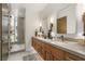 Luxury bathroom with double vanity sinks and a frameless glass shower enclosure at 13 Rockstream Dr, Henderson, NV 89012