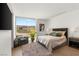 Bright bedroom with a large window showcasing outdoor views and modern decor at 13 Rockstream Dr, Henderson, NV 89012