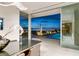 Chic dining area with city views, modern lighting, and access to a pool, perfect for evening gatherings at 13 Rockstream Dr, Henderson, NV 89012