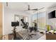 Bright exercise room with large windows, ceiling fan, and a variety of modern fitness equipment at 13 Rockstream Dr, Henderson, NV 89012