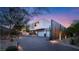 Modern two-story home with a well-lit driveway and desert landscaping at 13 Rockstream Dr, Henderson, NV 89012