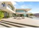 Stunning modern home with an expansive patio, pool, and outdoor seating area at 13 Rockstream Dr, Henderson, NV 89012