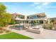 Striking modern home with infinity pool, fire pit, lush landscaping, and expansive patio area at 13 Rockstream Dr, Henderson, NV 89012
