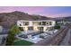 Stunning modern home with an infinity pool, fire pit, outdoor seating, and mountain views at 13 Rockstream Dr, Henderson, NV 89012