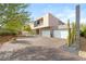 Contemporary home with desert landscaping, spacious driveway, and a modern three-car garage at 13 Rockstream Dr, Henderson, NV 89012
