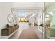 Bright foyer showcasing a sweeping staircase, modern decor, and seamless indoor-outdoor transition at 13 Rockstream Dr, Henderson, NV 89012