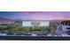 Modern two-story home with manicured desert landscaping and sunset views at 13 Rockstream Dr, Henderson, NV 89012