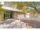 Stunning modern home showcasing a three-car garage, and attractive desert landscaping with cactus accents and glass entry door at 13 Rockstream Dr, Henderson, NV 89012