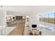 Open hallway with glass railings overlooking a modern fireplace and seating area at 13 Rockstream Dr, Henderson, NV 89012